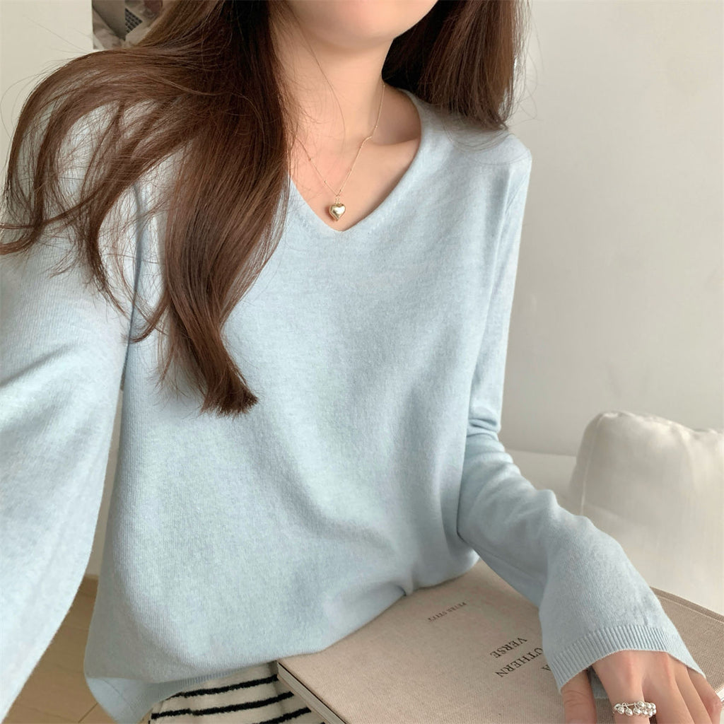 Women's loose V-neck soft cozy sweater for layering, featuring a relaxed fit and comfortable fabric in neutral tones.