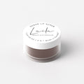 Laila Chocolate Lip Scrub in a jar, featuring a rich chocolate-colored sugar scrub with a smooth, textured surface for lip exfoliation.