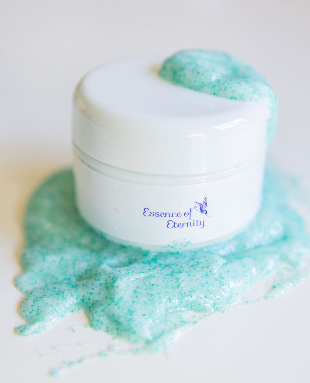 Essence of Eternity peppermint facial scrub in 30g jar, showcasing textured scrub particles and fresh peppermint scent.