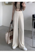 Women's high-waisted pleated casual pants by Dropshipman featuring lightweight fabric and draping design, shown in a neutral color.